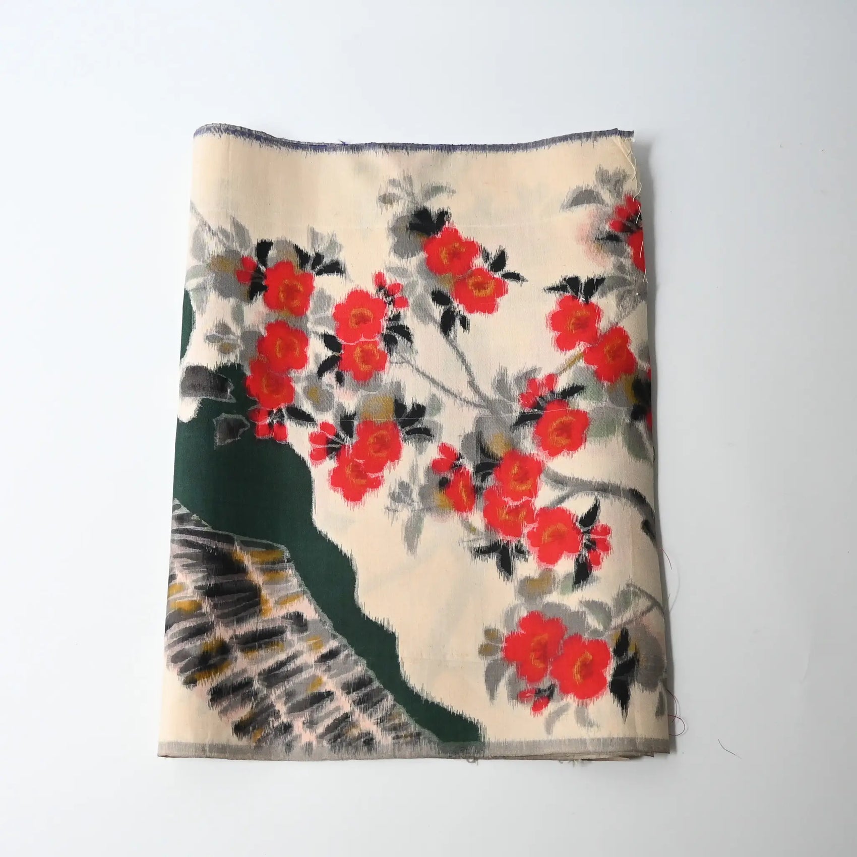 Vintage women's meisen silk kimono fabric piece with red plum blossom motif.