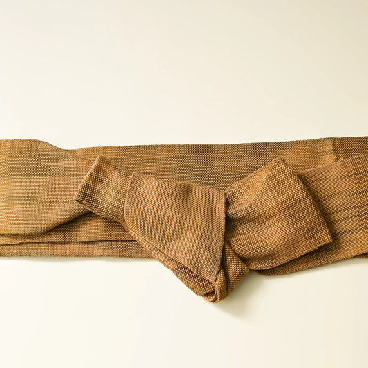 Vintage men's silk Kaku obi in earthy golden brown tied with a knot.