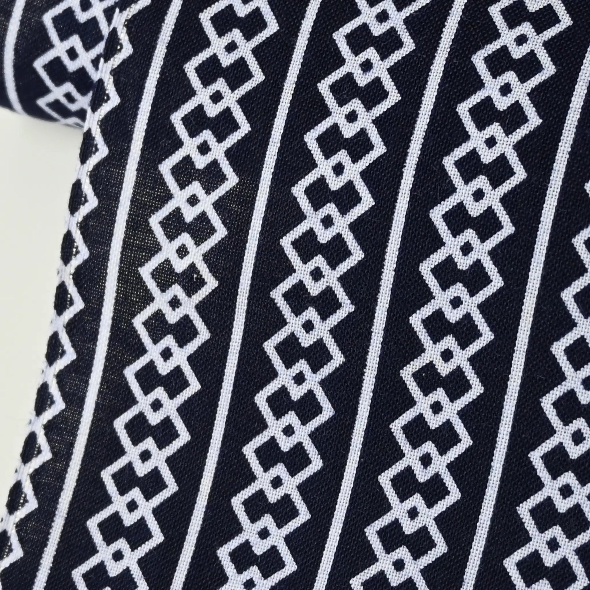 Close-up view of vintage Japanese men's yukata cotton in deep navy with traditional geometric pattern,  Yoshiwara-tsunagi.