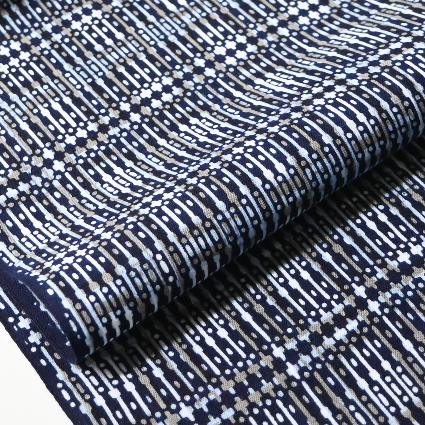 Close-up view of vintage men's yukata cotton fabric with geometric pattern, sold by the metre.