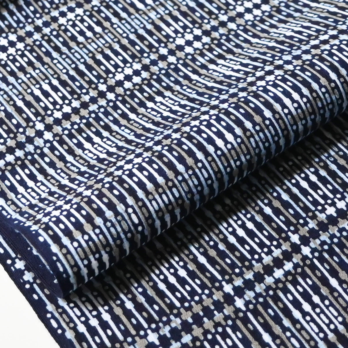 Close-up view of vintage men's yukata cotton fabric with geometric pattern, sold by the metre.