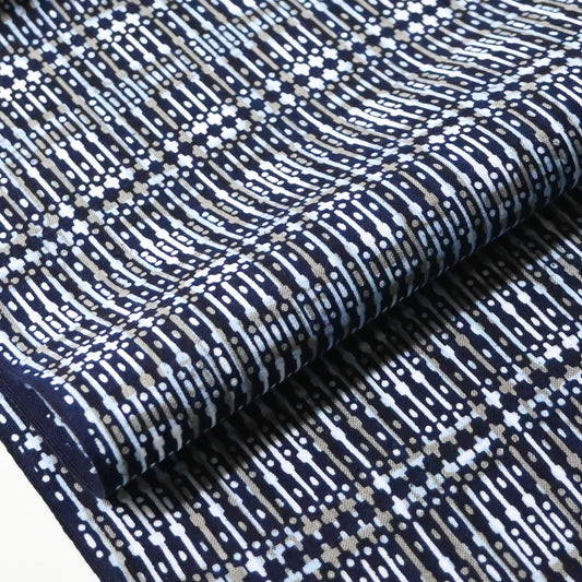 Close-up view of vintage men's yukata cotton fabric with geometric pattern, sold by the metre.