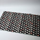 Full view of vintage Meisen silk kimono fabric piece, stylised vase motif in white and pink against black.