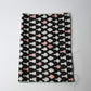 Vintage Meisen silk kimono fabric piece, stylised vase motif in white and pink against black.