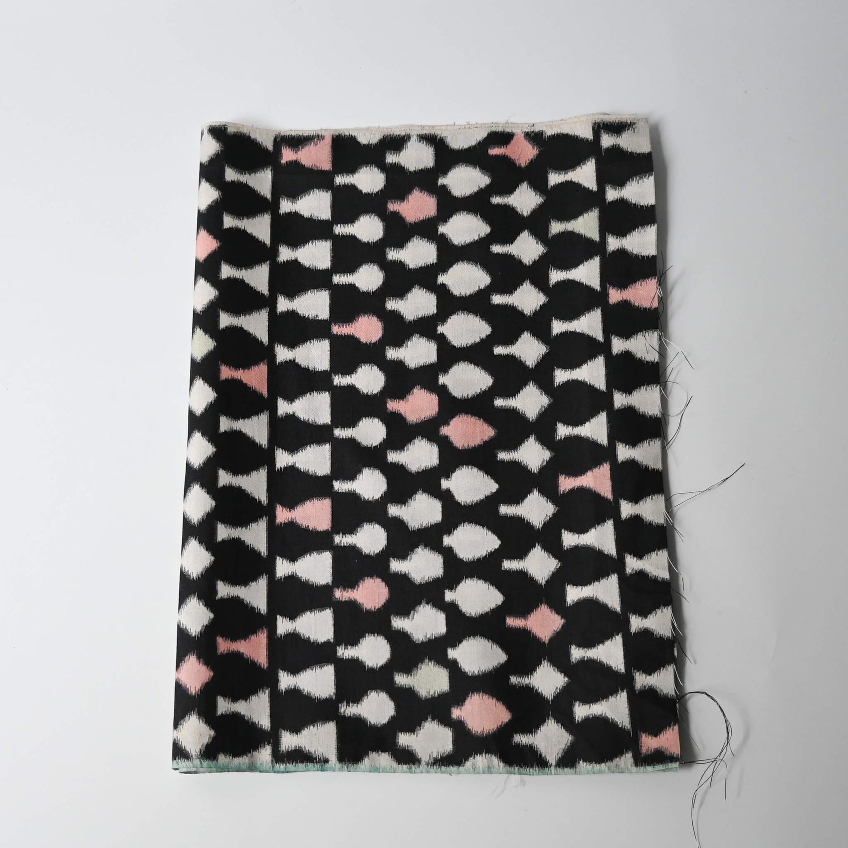 Vintage Meisen silk kimono fabric piece, stylised vase motif in white and pink against black.