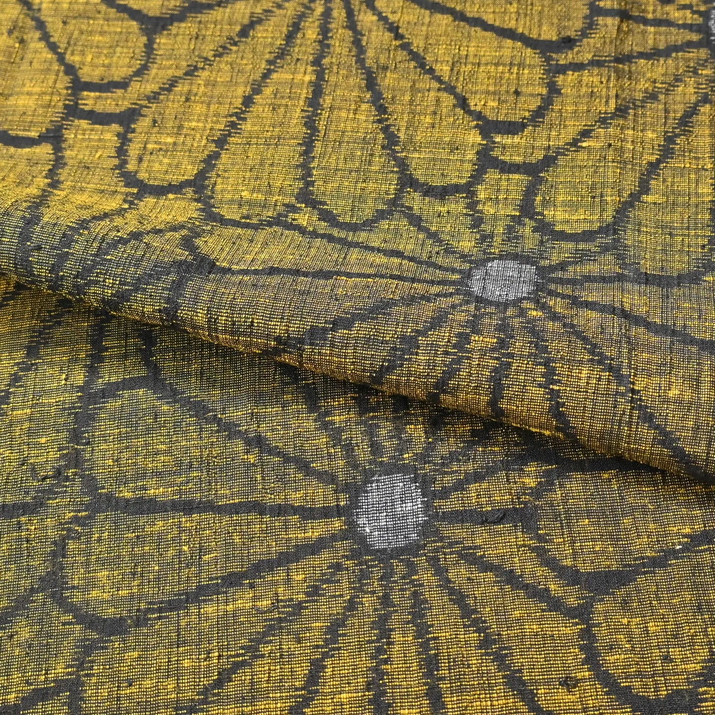 Detailed view of vintage Japanese tsumugi silk kimono fabric with a bold chrysanthemum motif.