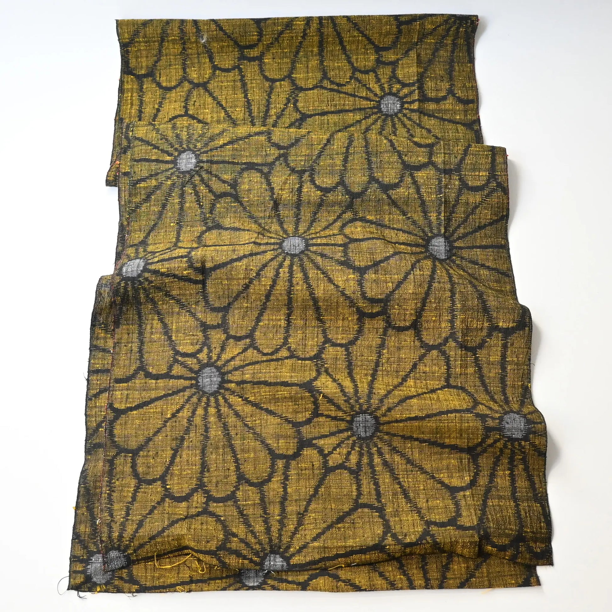 Full view of vintage Japanese tsumugi silk kimono fabric with a bold chrysanthemum motif.