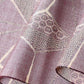 Close-up view of vintage tsumugi silk kimono fabric in muted mauve tone with a large-scale asanoha motif.