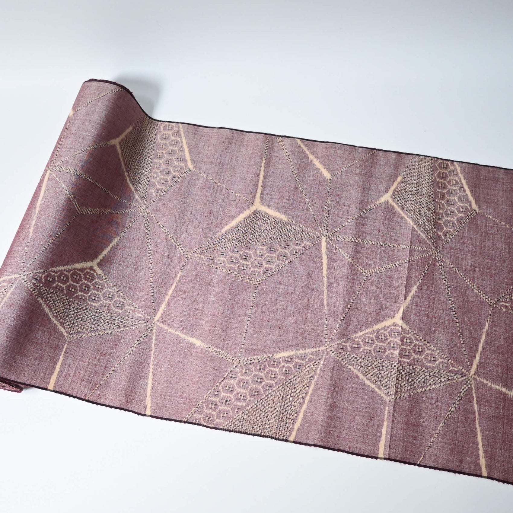 Vintage tsumugi silk kimono fabric in muted mauve tone with a large-scale asanoha motif.