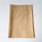 Vintage tsumugi silk kimono fabric piece in a warm, muted yellow tone, gentle sheen.