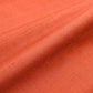 Close-up view of vintage hand-spun tsumugi silk kimono fabric naturally dyed with safflower, sold by the metre.