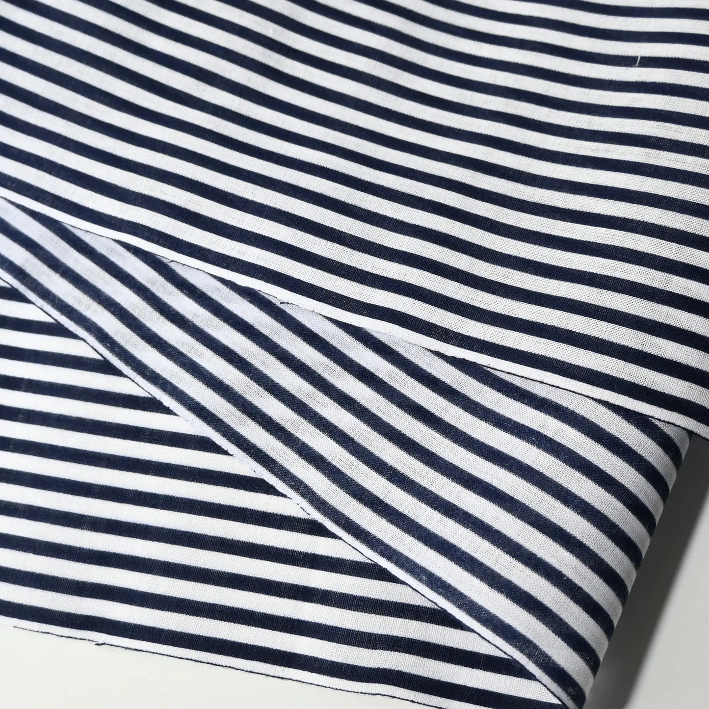 Close-up view of vintage navy and white stripe yukata cotton fabric sold by the metre.