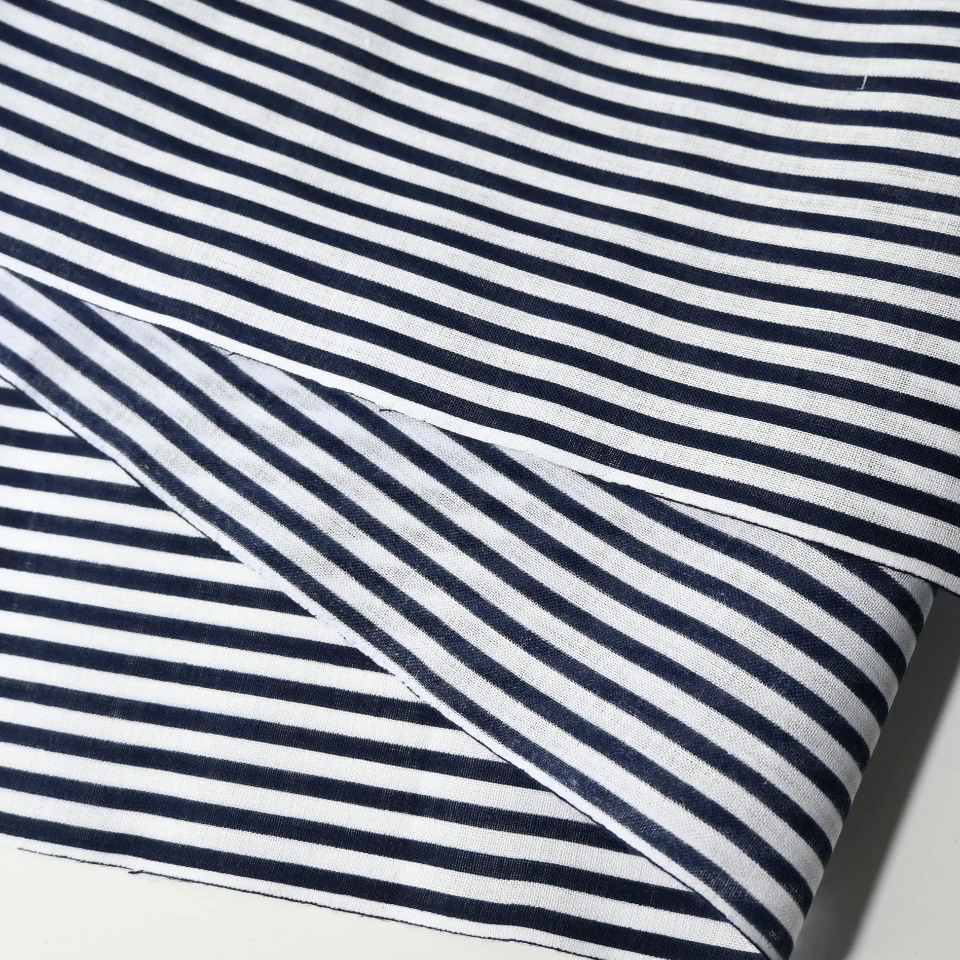 Close-up view of vintage navy and white stripe yukata cotton fabric sold by the metre.