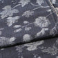 Close-up view of vintage tsumugi silk kimono fabric with silver grey vine floral pattern on a navy ground.