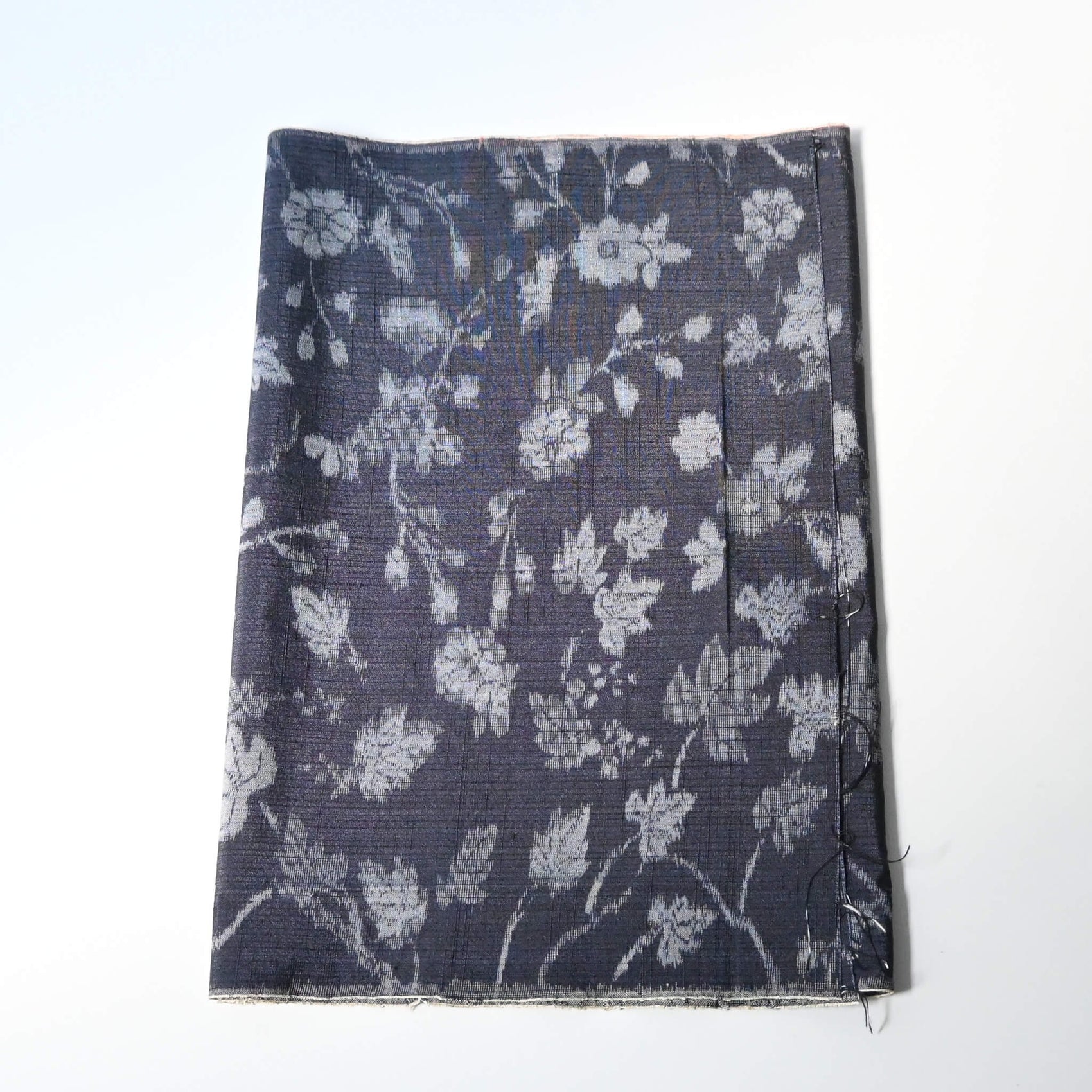 Vintage tsumugi silk kimono fabric with silver grey vine floral pattern on a navy ground.