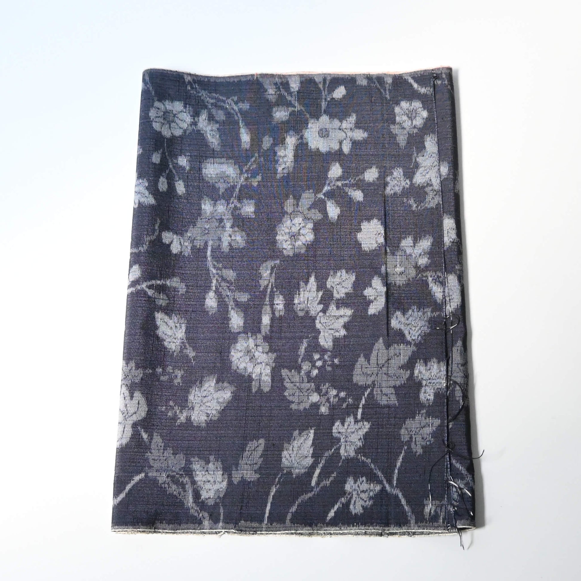 Vintage tsumugi silk kimono fabric with silver grey vine floral pattern on a navy ground.