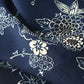 Close-up view of vintage Chirimen  silk crepe kimono fabric in navy with traditional Japanese seasonal flowers and trees.