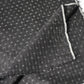 Detailed view of vintage silk kimono in dark navy with small kasuri woven pattern from the mid-20th century.