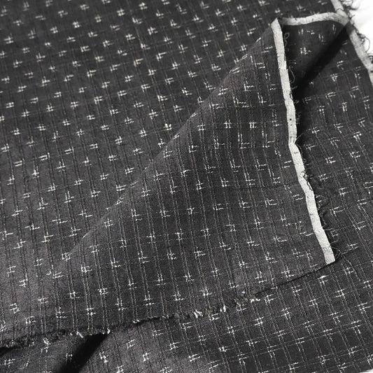 Detailed view of vintage silk kimono in dark navy with small kasuri woven pattern from the mid-20th century.