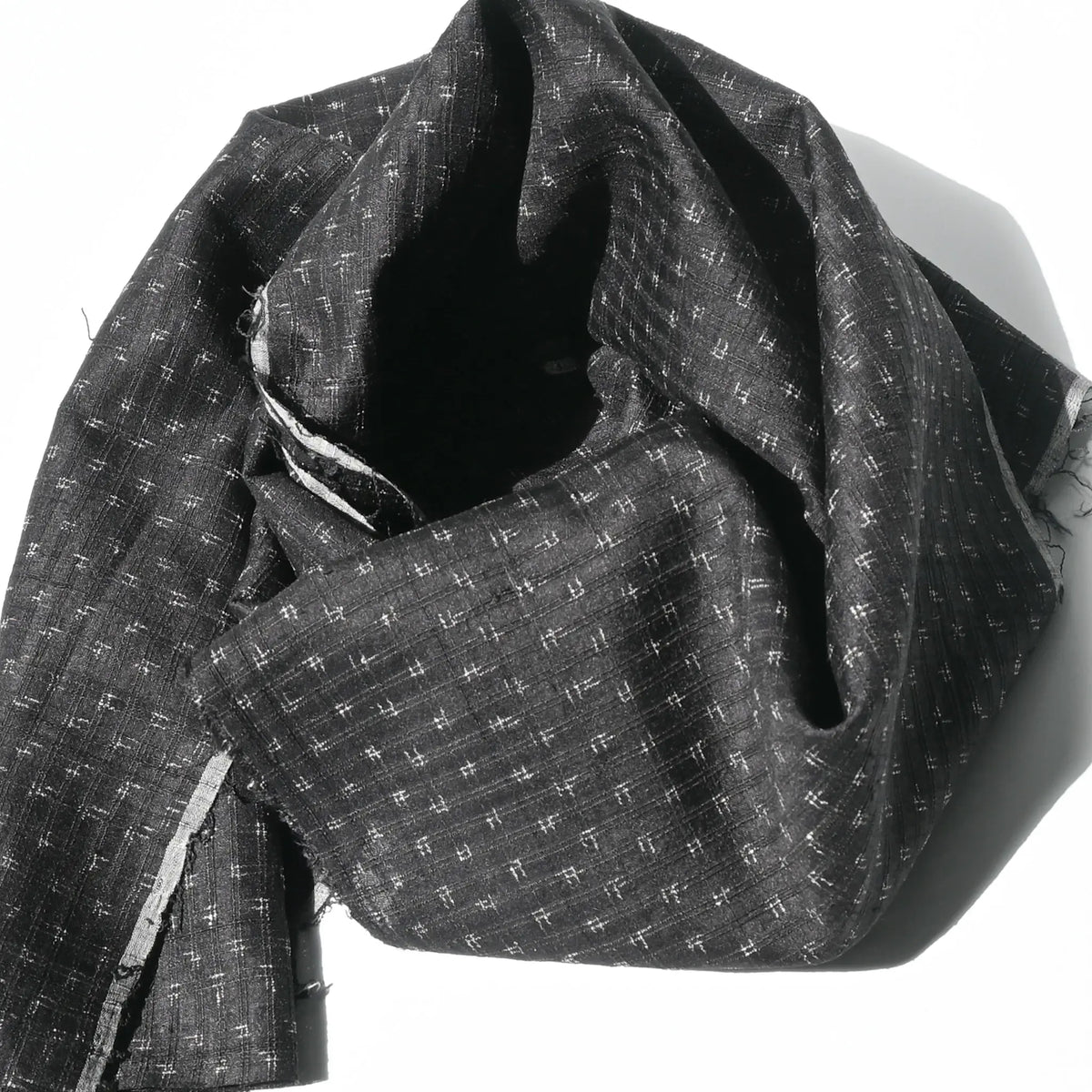Detailed view of vintage silk kimono in dark navy with small kasuri woven pattern from the mid-20th century.