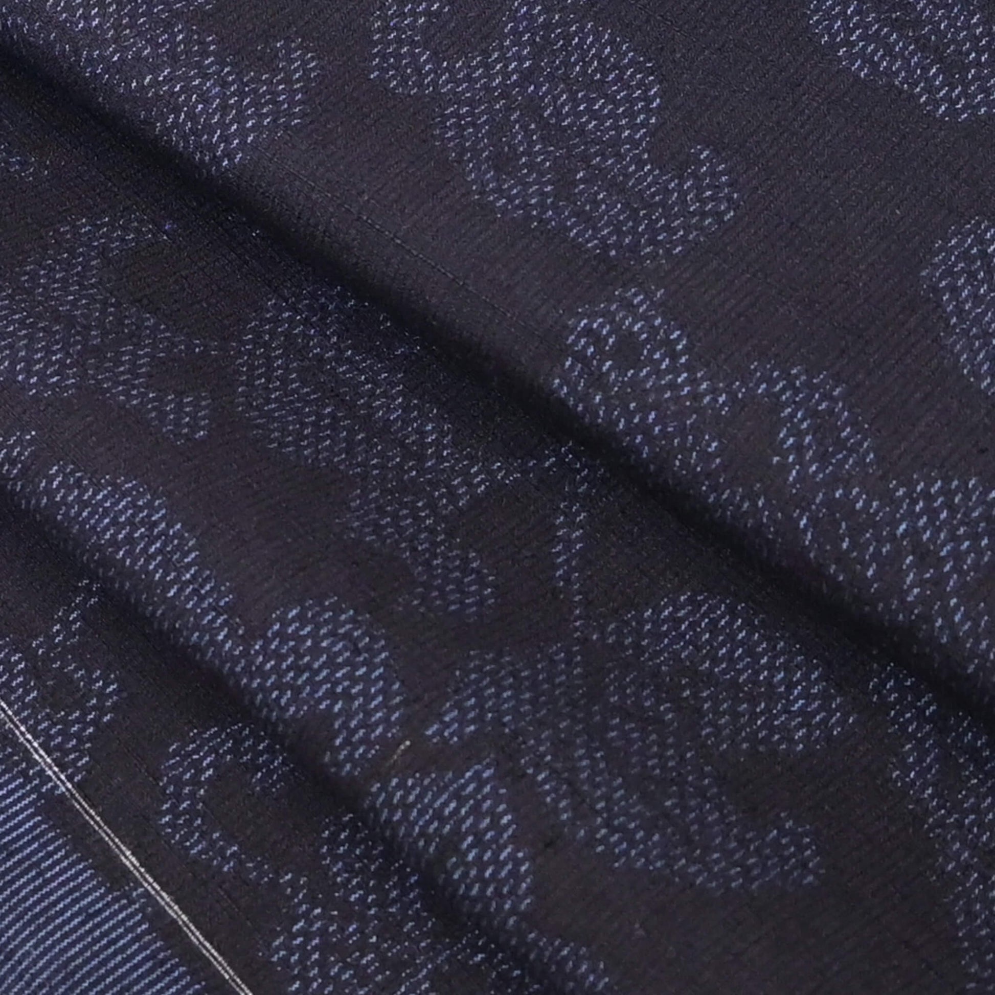 Close-up view of vintage navy tsumugi silk kimono fabric with peony foliage pattern, sold by the metre.