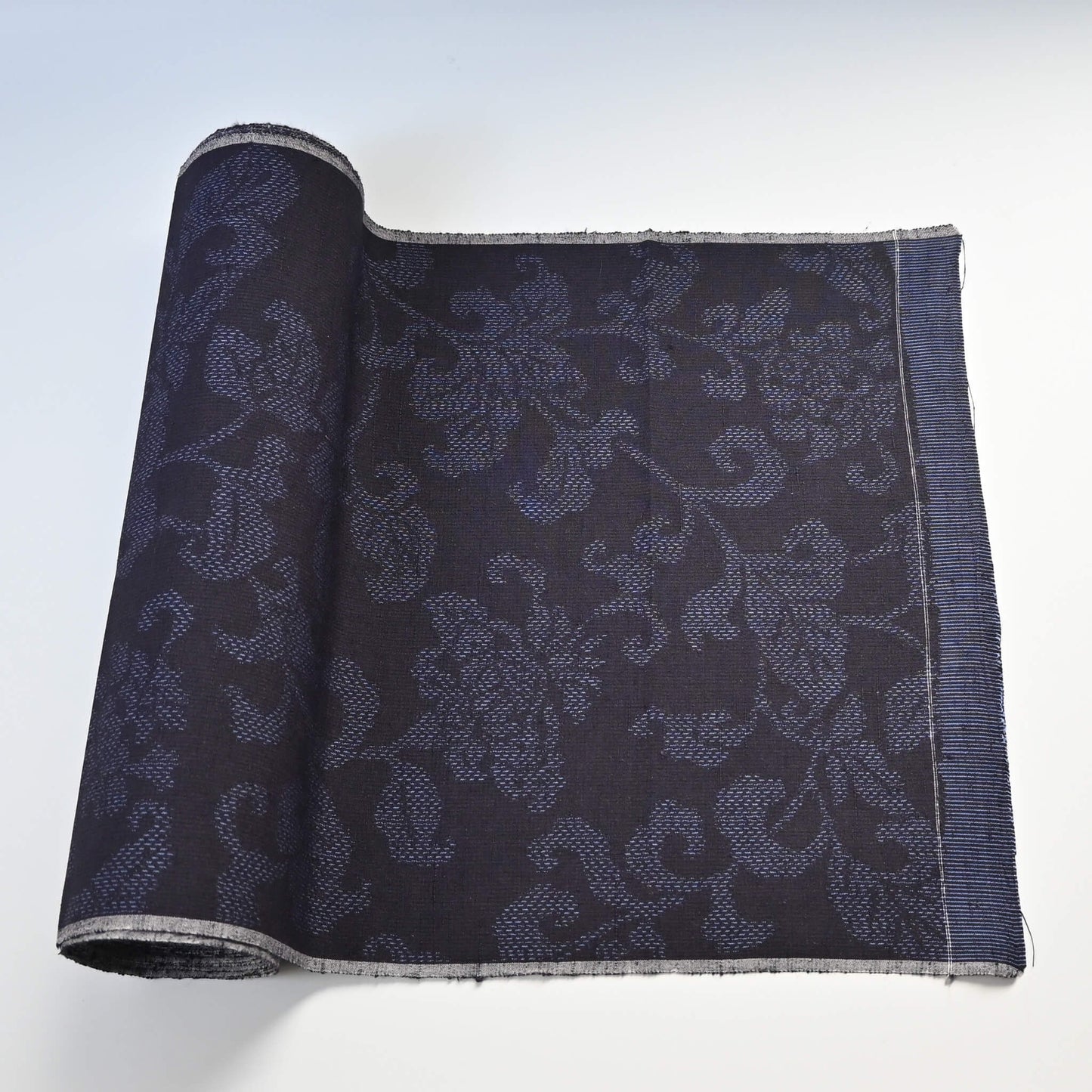 Vintage navy tsumugi silk kimono fabric with peony foliage pattern, sold by the metre.