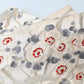 Close-up view of vintage women's off-white silk fukuro obi with elegant plum blossom motif.