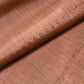 Detailed view of vintage pink brown tsumugi silk kimono fabric roll sold by the metre.
