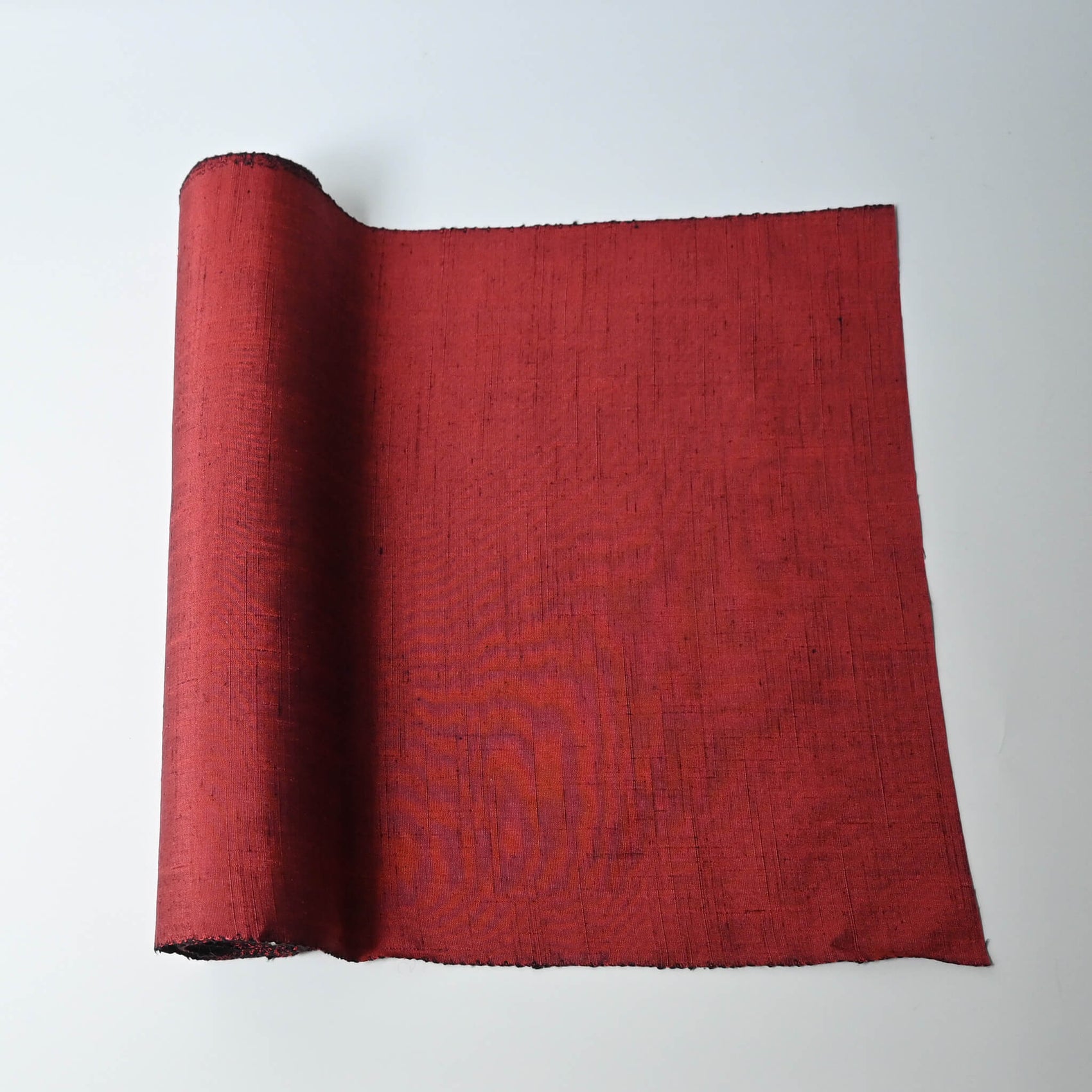 Vintage plain tsumugi silk kimono fabric in brick red tone, sold by the metre.