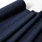 Close-up view of vintage plain tsumugi silk kimono fabric in deep blue sold by the metre.