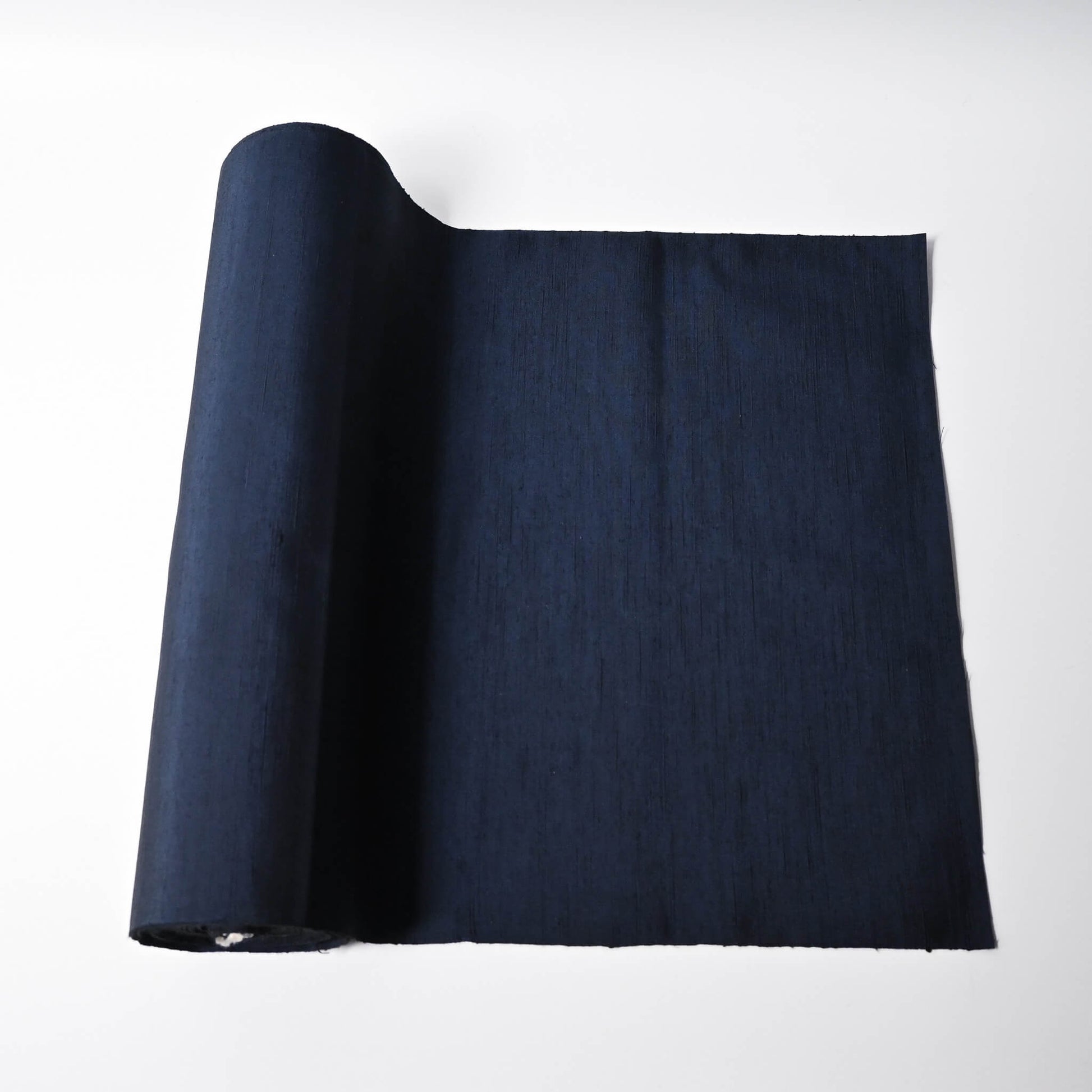Vintage plain tsumugi silk kimono fabric in deep blue sold by the metre.