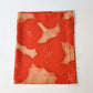 Vintage Japanese tsumugi silk kimono fabric piece in reddish orange with bold plum blossom.