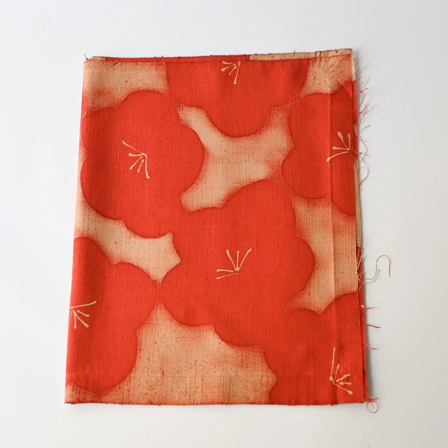 Vintage Japanese tsumugi silk kimono fabric piece in reddish orange with bold plum blossom.