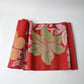 Vintage Japanese red ro silk Nagoya obi fabric roll with a bold lily motif.