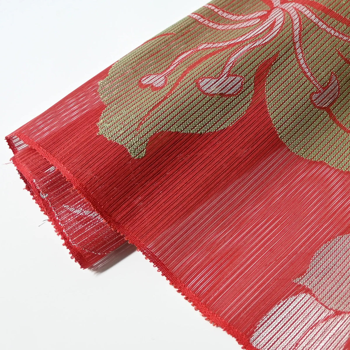 Detailed view of vintage Japanese red ro silk obi fabric, open weave.
