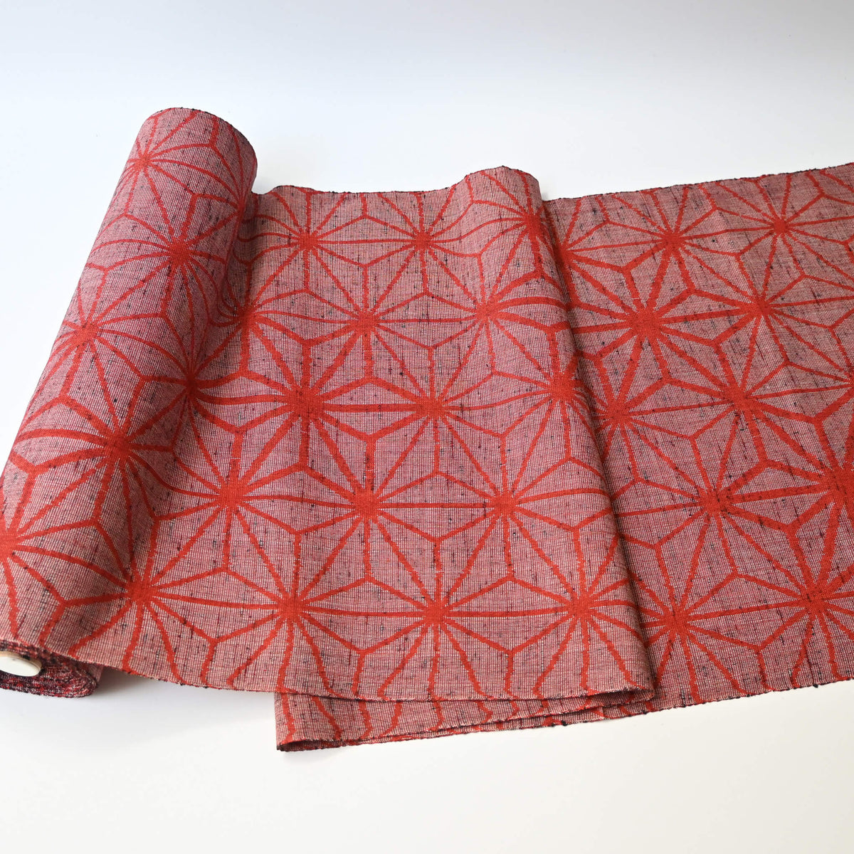 Vintage wool kimono fabric in red with bold asanoha motif, sold by the metre.