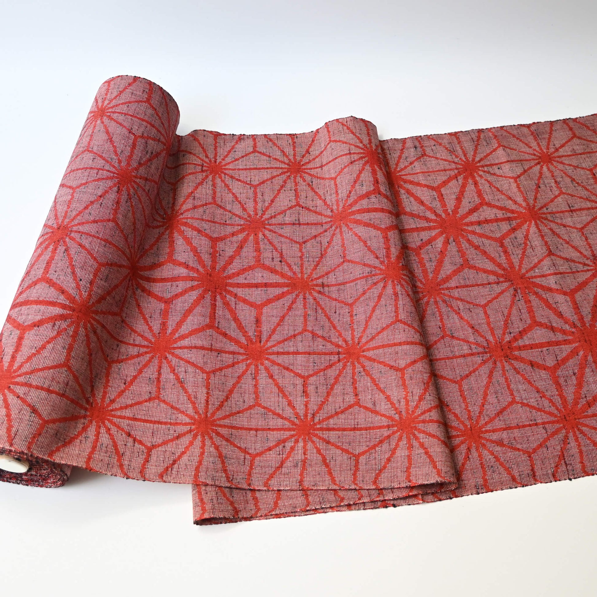 Vintage wool kimono fabric in red with bold asanoha motif, sold by the metre.