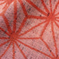 Close-up view of vintage wool kimono fabric in red with bold asanoha motif, sold by the metre.