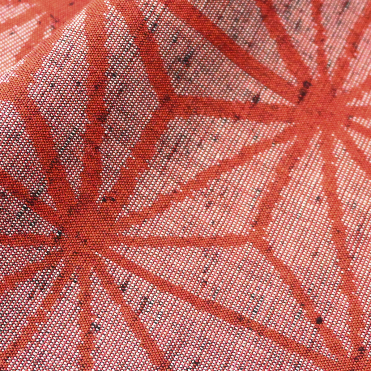 Close-up view of vintage wool kimono fabric in red with bold asanoha motif, sold by the metre.
