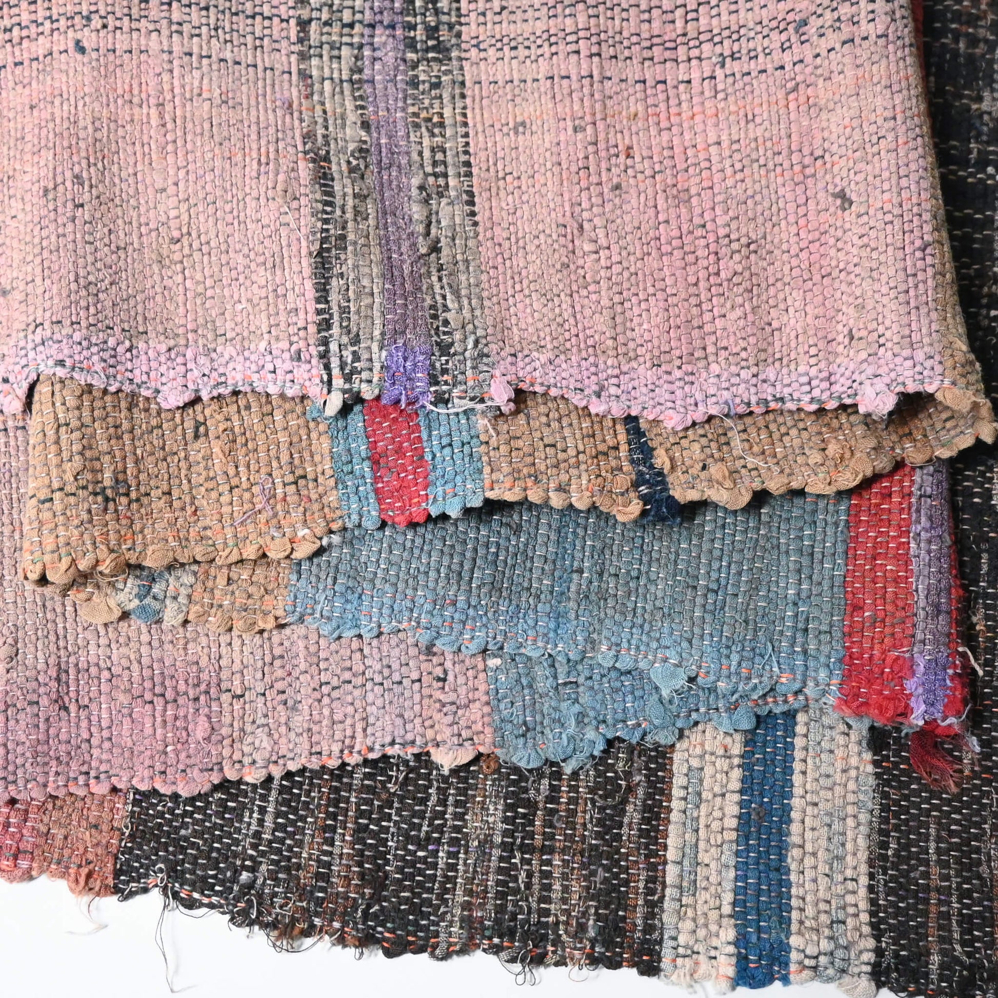 Close-up view of vintage Sakiori fragment cloth from Tohoku region, woven from shredded strips of recycled kimono and futon covers.