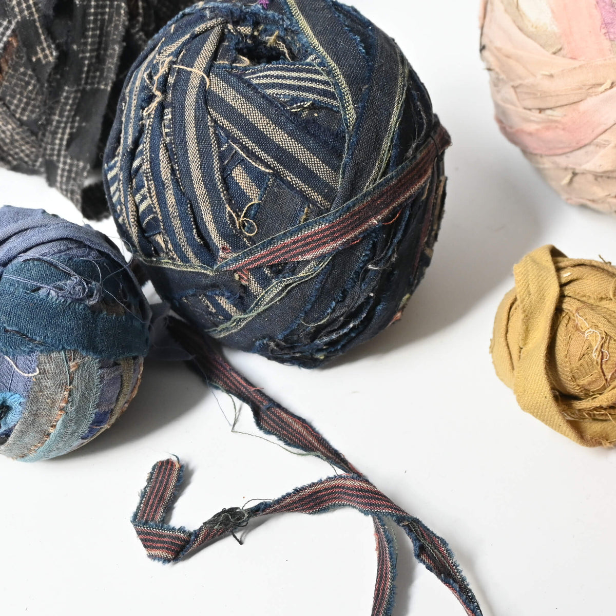 Detailed view of vintage sakiori weaving yarn ball collection, stripped recycled old kimono fabrics, rare find.