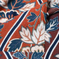Close-up view of vintage Japanese Sarasa cotton piece with peony pattern in warm rust orange and navy, inspired by imported chintz designs.
