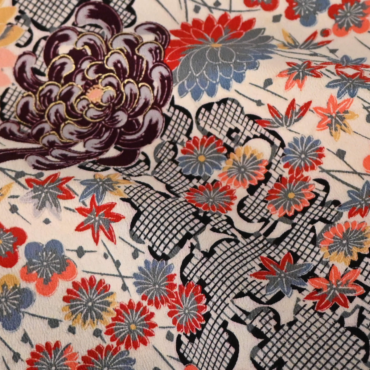 Close-up view of vintage women's ivory silk crepe haori with an all-over multicoloured Japanese floral pattern.
