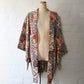 Vintage women's ivory silk crepe haori with an all-over multicoloured Japanese floral pattern.

