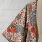 Vintage women's ivory silk crepe haori with an all-over multicoloured Japanese floral pattern.
