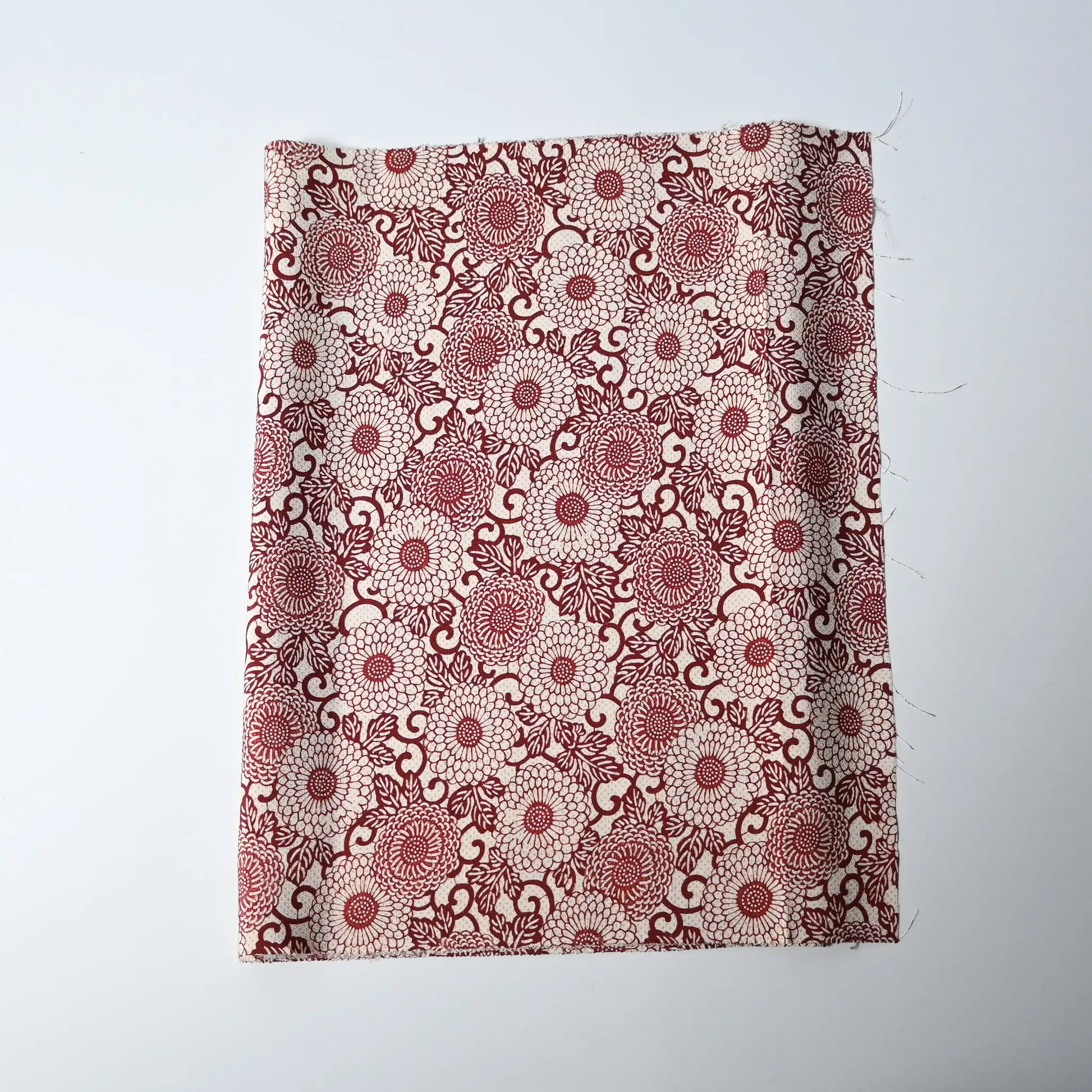 Vintage Japanese silk crepe kimono fabric with chrysanthemum arabesque motif in burgundy red.