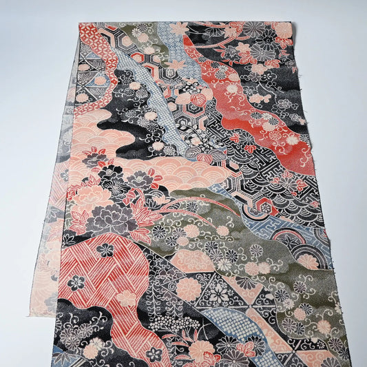 Vintage silk crepe kimono fabric with many traditional Japanese seasonal flowers and auspicious motifs in multiple colours.
