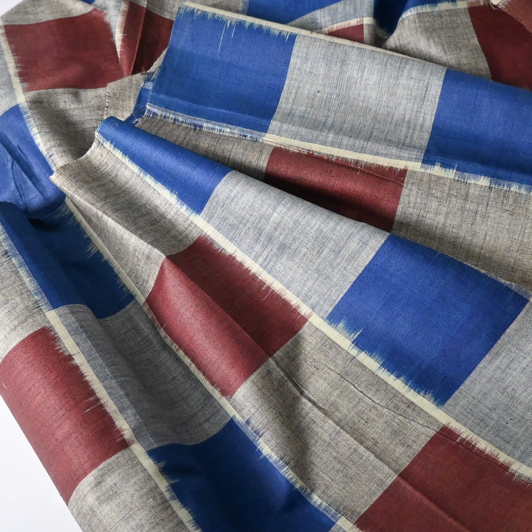 close-up view of vintage Japanese silk Haori lining fabric sold by the metre, large scale check pattern in blue and brown.