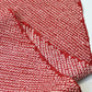Close-up view of vintage silk kanoko shibori kimono fabric in rich burgundy red.