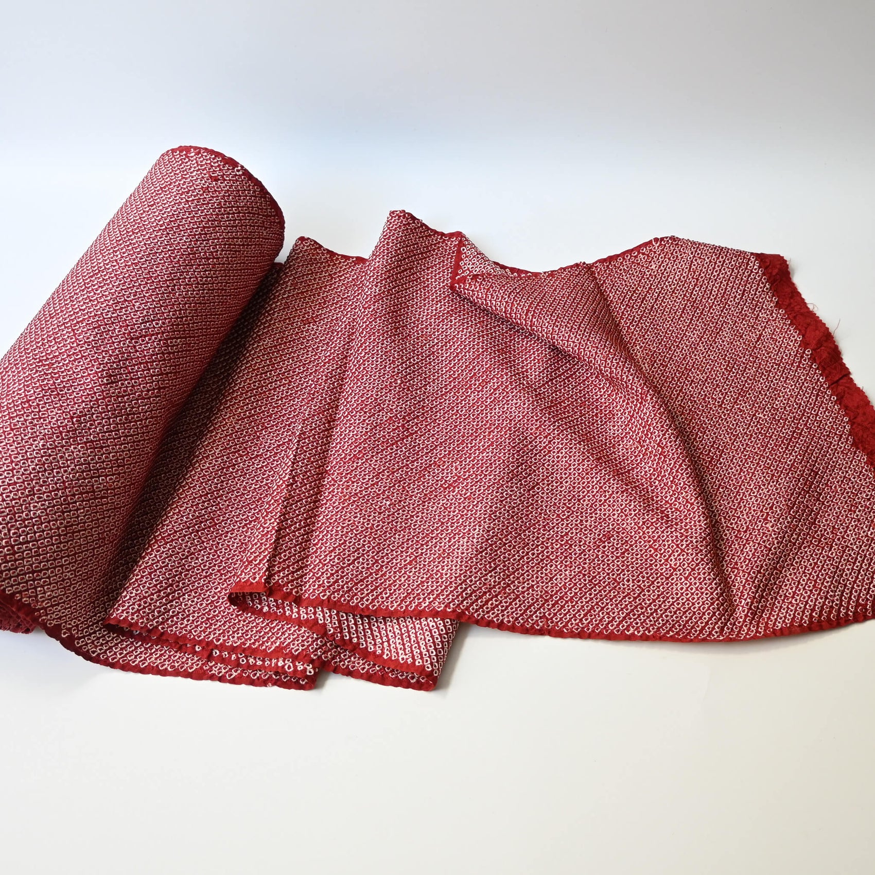 Full view of vintage silk kanoko shibori kimono fabric in rich burgundy red.